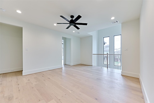 spare room featuring ceiling fan and light hardwood / wood-style floors