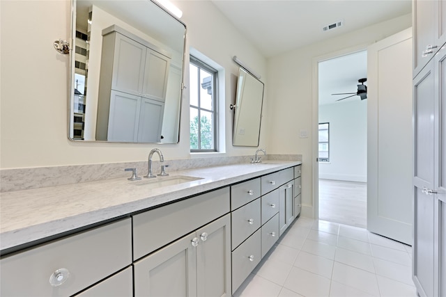 bathroom with ceiling fan, tile patterned flooring, and vanity