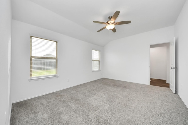 unfurnished room featuring ceiling fan, lofted ceiling, carpet flooring, and a wealth of natural light