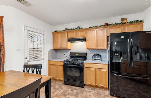 kitchen with black appliances and tasteful backsplash