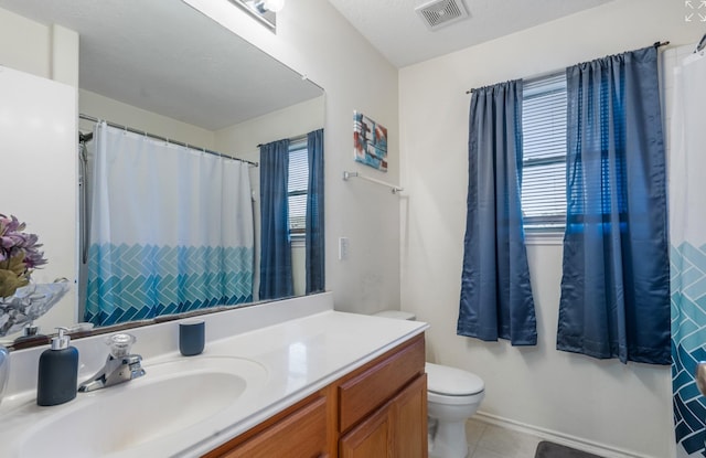 bathroom featuring vanity, toilet, and tile patterned floors