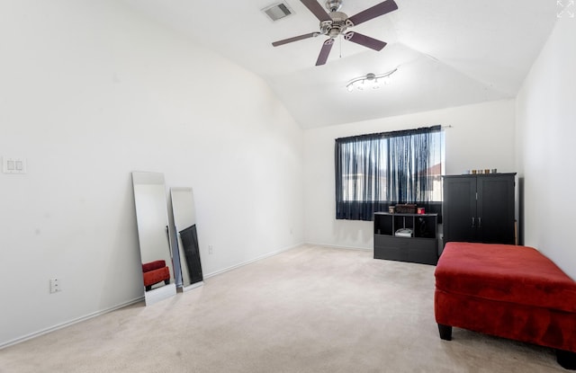 living area with light colored carpet, vaulted ceiling, and ceiling fan