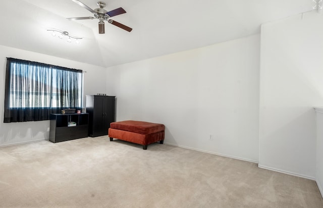 living area with vaulted ceiling, carpet, and ceiling fan