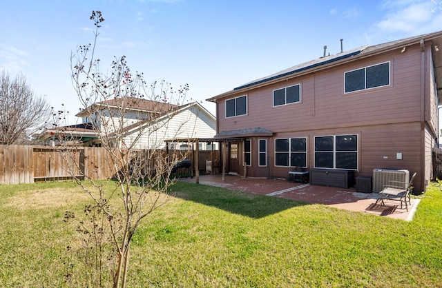 rear view of house with central AC, a yard, and a patio