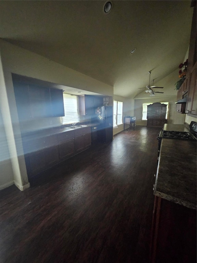 unfurnished living room with dark hardwood / wood-style flooring, ceiling fan, lofted ceiling, and sink