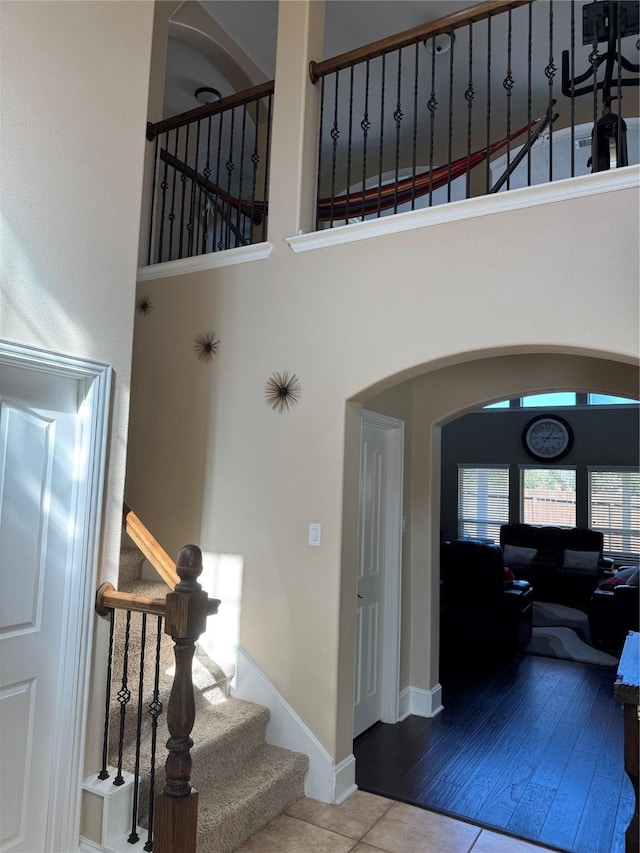 entrance foyer with tile patterned floors and a towering ceiling