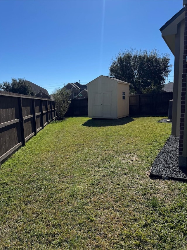 view of yard featuring a storage unit and central air condition unit