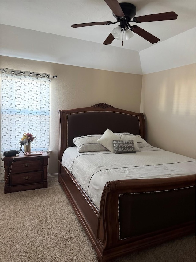 carpeted bedroom with vaulted ceiling and ceiling fan