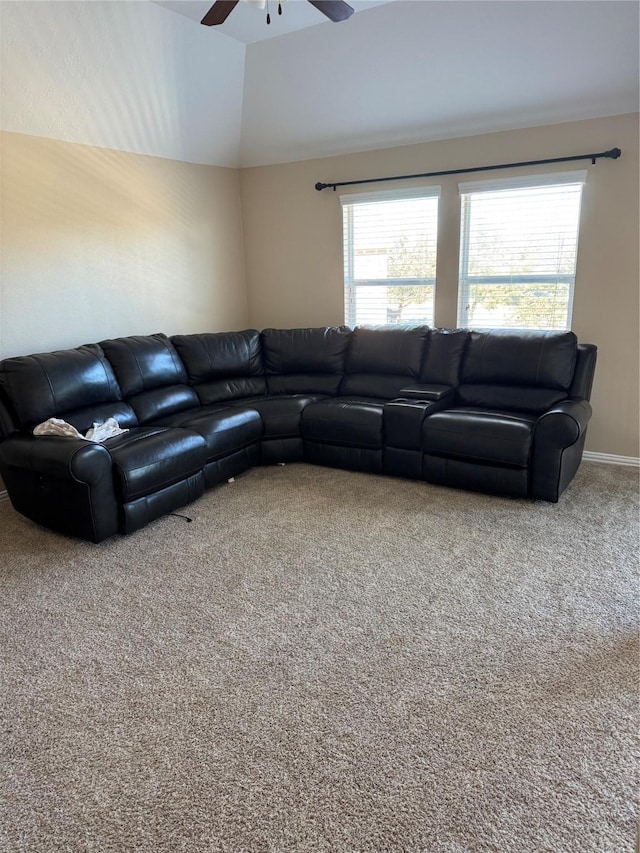 carpeted living room featuring ceiling fan and vaulted ceiling