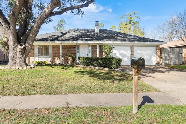 single story home featuring a garage and a front lawn