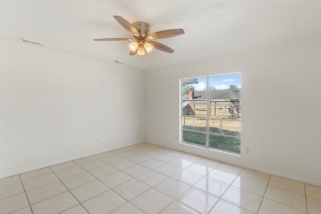 tiled spare room featuring ceiling fan