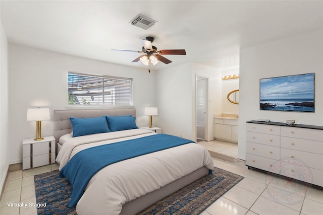 tiled bedroom featuring ceiling fan and connected bathroom