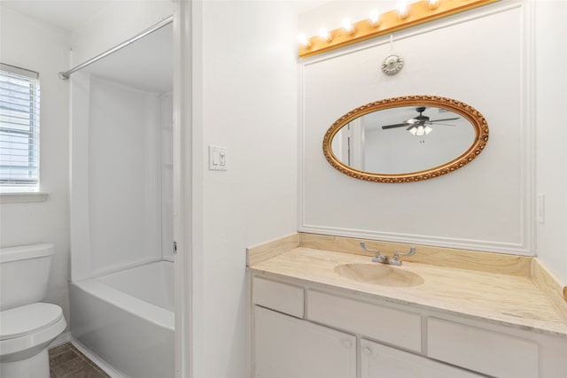 full bathroom featuring vanity, toilet, ceiling fan, and tub / shower combination