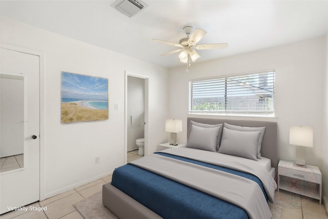 tiled bedroom with connected bathroom and ceiling fan