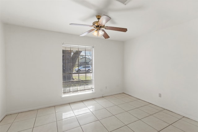 tiled empty room with ceiling fan