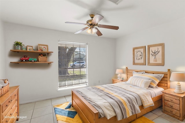 bedroom with ceiling fan and light tile patterned flooring