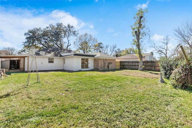 back of house featuring a yard and a carport