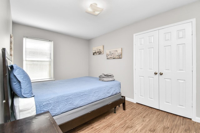 bedroom with a closet and light hardwood / wood-style floors