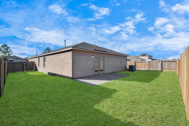 back of house featuring french doors, a yard, a patio, and central AC