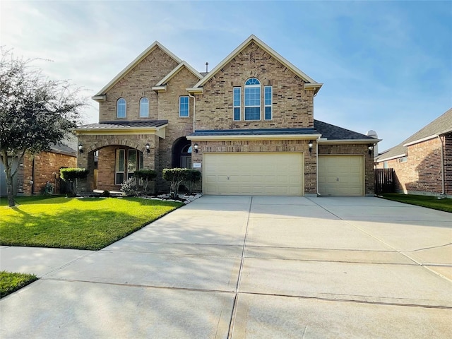 view of front of property featuring a front lawn and a garage