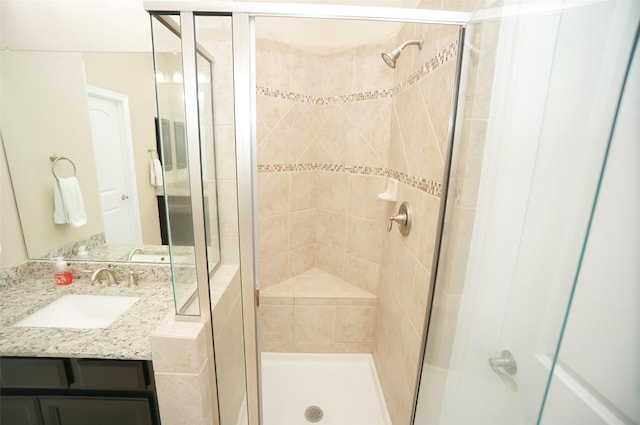 bathroom with vanity and a shower with shower door