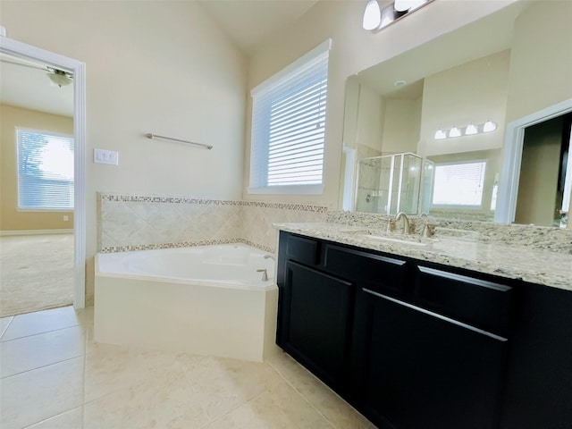 bathroom featuring tile patterned flooring, vanity, shower with separate bathtub, and vaulted ceiling