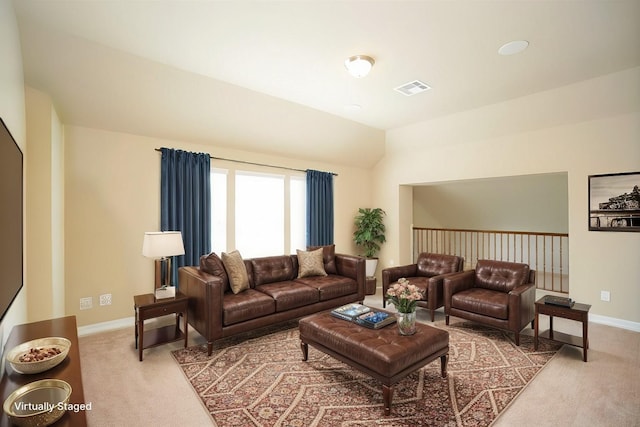 carpeted living room with vaulted ceiling