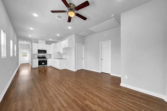 unfurnished living room featuring ceiling fan, sink, and dark wood-type flooring