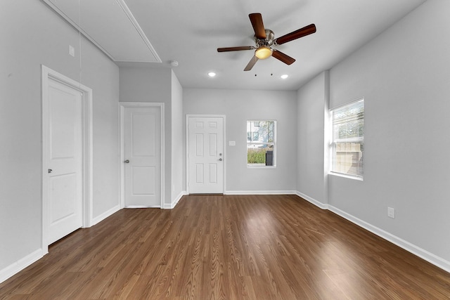 unfurnished room with ceiling fan and dark hardwood / wood-style floors