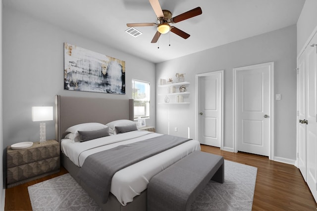 bedroom featuring ceiling fan and dark wood-type flooring