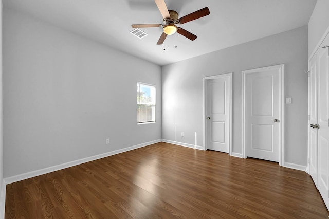 unfurnished bedroom featuring ceiling fan and dark hardwood / wood-style flooring