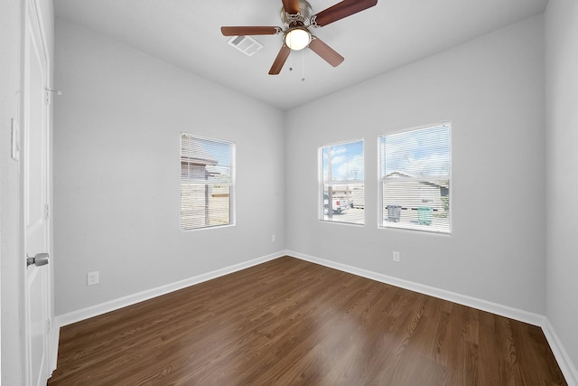 empty room featuring ceiling fan and dark wood-type flooring