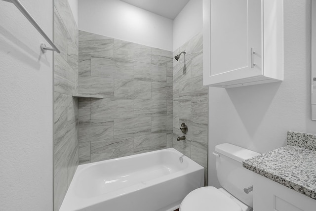 full bathroom with vanity, tiled shower / bath combo, and toilet