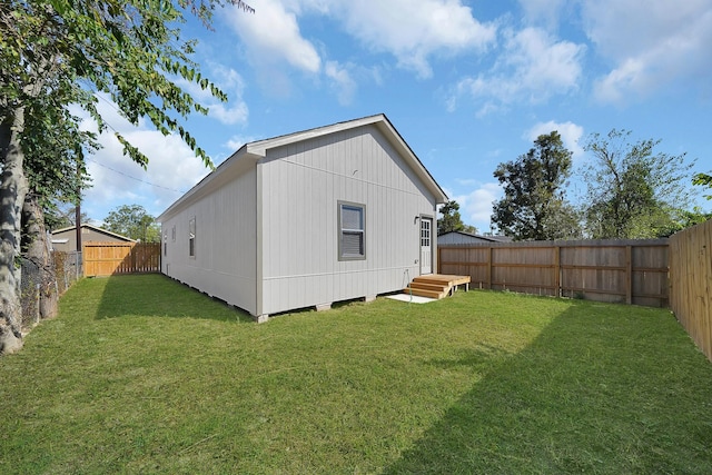 rear view of property with a yard