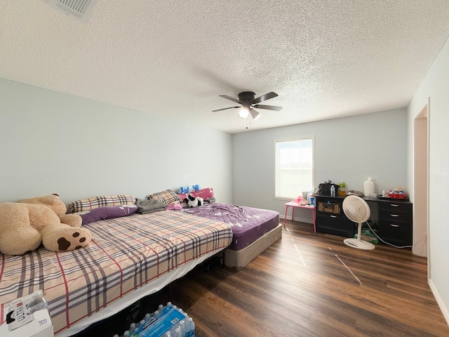 bedroom featuring a textured ceiling, dark hardwood / wood-style flooring, and ceiling fan