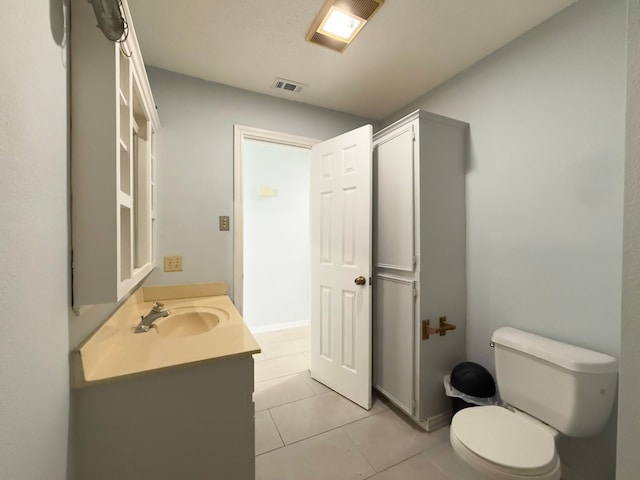 bathroom featuring toilet, vanity, and tile patterned floors