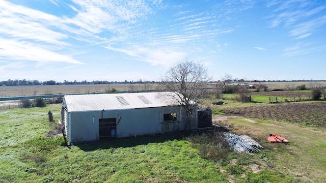 exterior space featuring a rural view and an outdoor structure