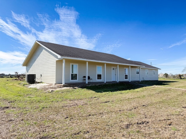 view of front facade with a front yard and cooling unit