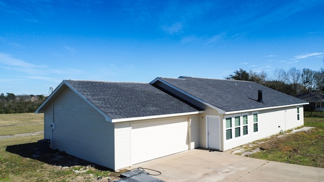 view of front of property with a front lawn and a garage