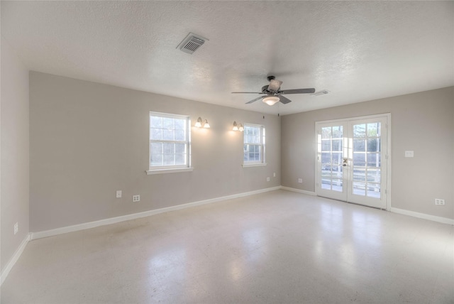 empty room with french doors, a textured ceiling, and ceiling fan