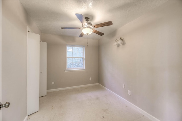 empty room with a textured ceiling and ceiling fan