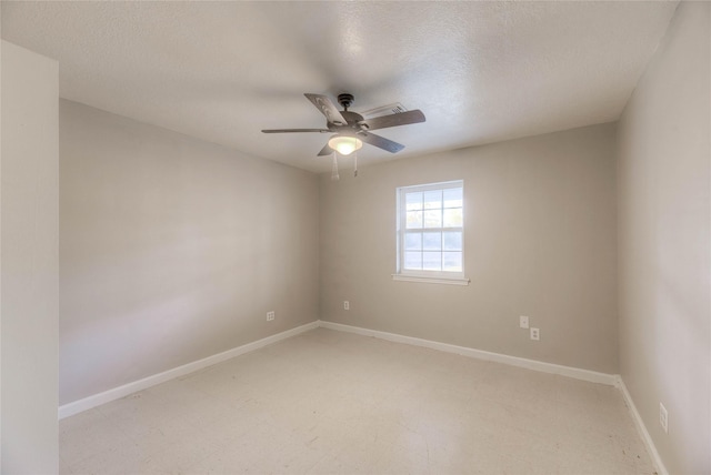 empty room with ceiling fan and a textured ceiling