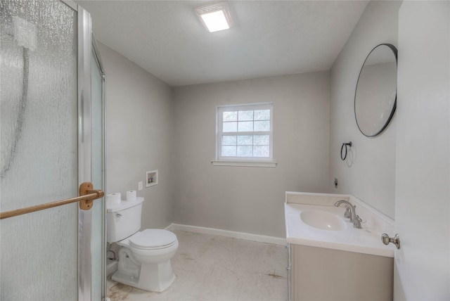 bathroom featuring vanity, toilet, and a textured ceiling