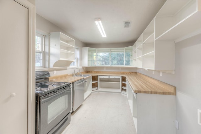 kitchen featuring black electric range, light floors, open shelves, and dishwasher