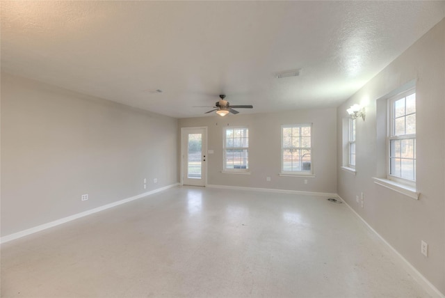 unfurnished room featuring baseboards, visible vents, a ceiling fan, and tile patterned floors