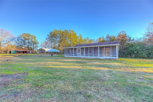 view of yard featuring a sunroom and a carport