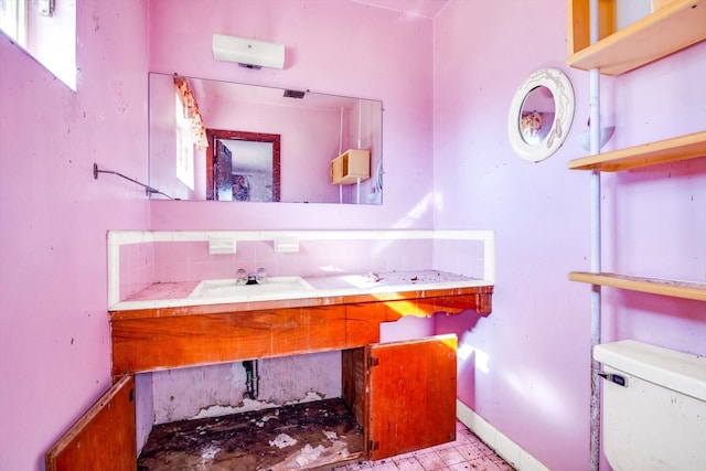 bathroom with vanity, tasteful backsplash, and toilet