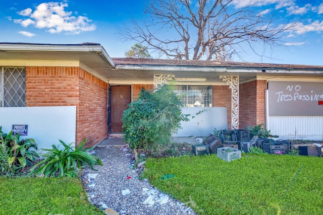 doorway to property with a yard