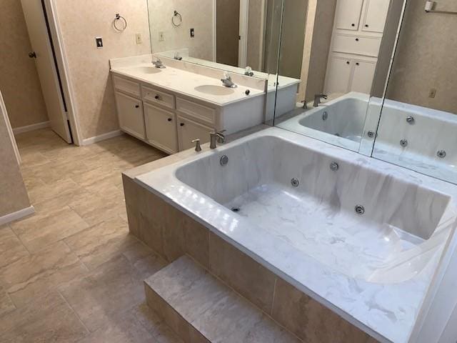 bathroom with vanity and tiled tub