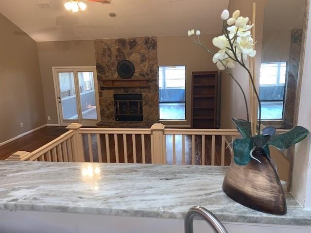 interior space featuring a fireplace, hardwood / wood-style flooring, plenty of natural light, and ceiling fan